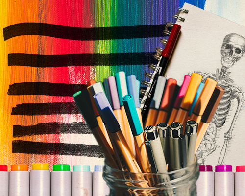 Article 02 cover - a cup containing assorted stationery items, mostly pens, since in front of a row of markers, a notebook with a skeleton on it and a rainbow background